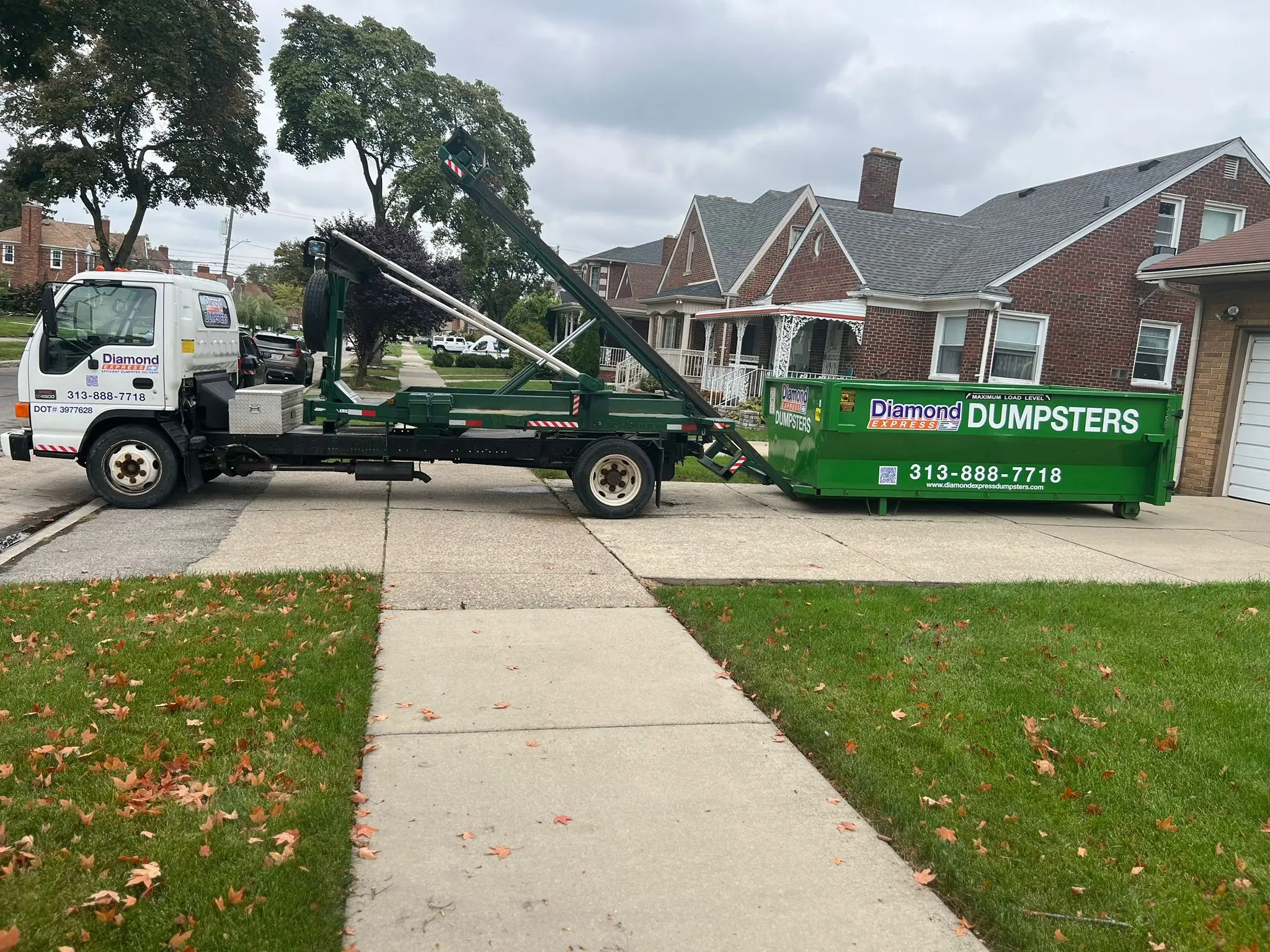 Diamond Express Dumpster Rental truck delivering a roll-off dumpster in Metro Detroit
